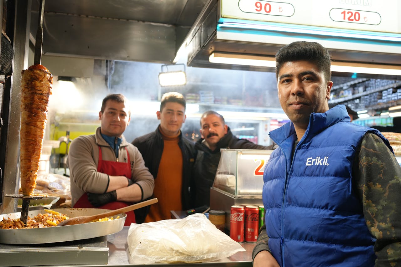 Street food vendors serving delicious Turkish kebabs at a busy outdoor market.