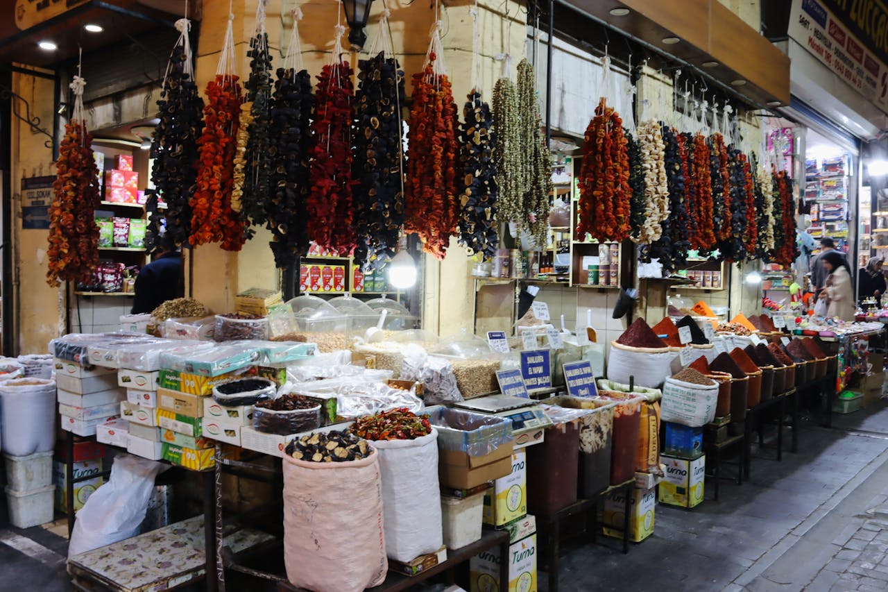 Vibrant spice market scene in Şanlıurfa, Türkiye showcasing dried peppers and assorted herbs.